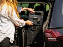 The L PowerStation being put into the back of a vehicle with a KitchenBox - TentBox