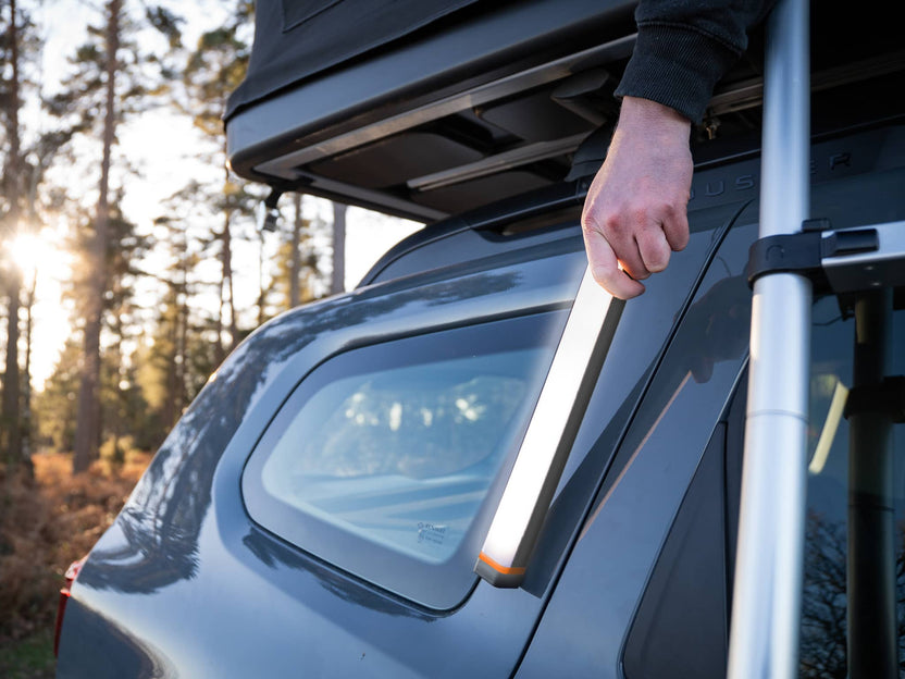 ABL - TentBox Bar Light being magnetically attached to a car