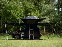 TentBox Lite 2.0 Living Pod mounted on a small car in a woodland setting