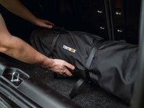 Person demonstrating how to store the Lite 2.0 Living Pod in the boot of a car
