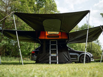 TentBox Lite XL Living Pod with panels opened, helping protect customer from the rain