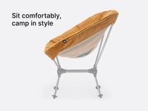 An image showing a side angle of the TentBox Camping Chair cushion in mustard with overlay text saying "Sit comfortably, camp in style"