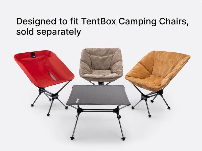 Three TentBox Camping Chairs in red, grey, and mustard are arranged around a Camping Table on a light grey background, with the text 'Designed to fit TentBox Camping Chairs, sold separately' at the top.