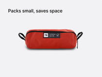 the TentBox Camping Chair in red, packed down into its convenient, compact-sized storage bag