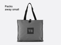 The TentBox Camping Chair Cushion packed away into a convenient, stylish stone-coloured storage bag, with overlay text saying "Packs away small"