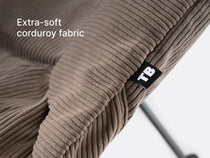A close-up of the TentBox Camping Chair cushion in mustard showing the abbreviated "TB" logo and overlay text saying "premium corduroy warmth"