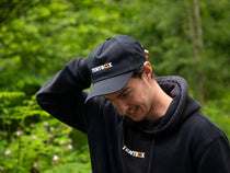 Man adjusting the TentBox Cap whilst in the forest