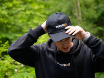 TentBox Cap worn by a man in the forest