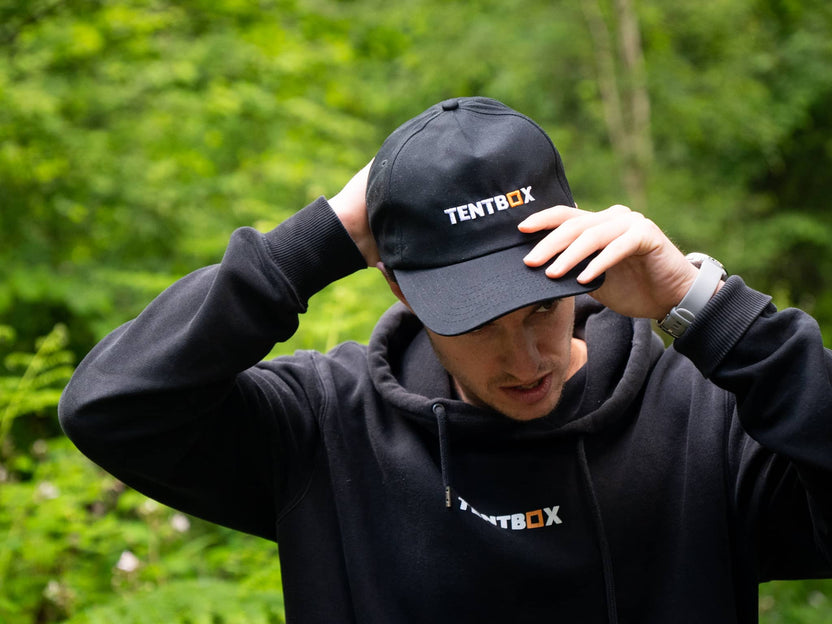 TentBox Cap worn by a man in the forest