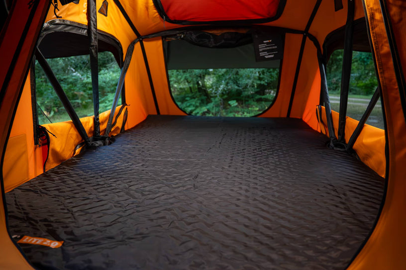 interior of a TentBox Lite with the mattress topper in use, forest setting