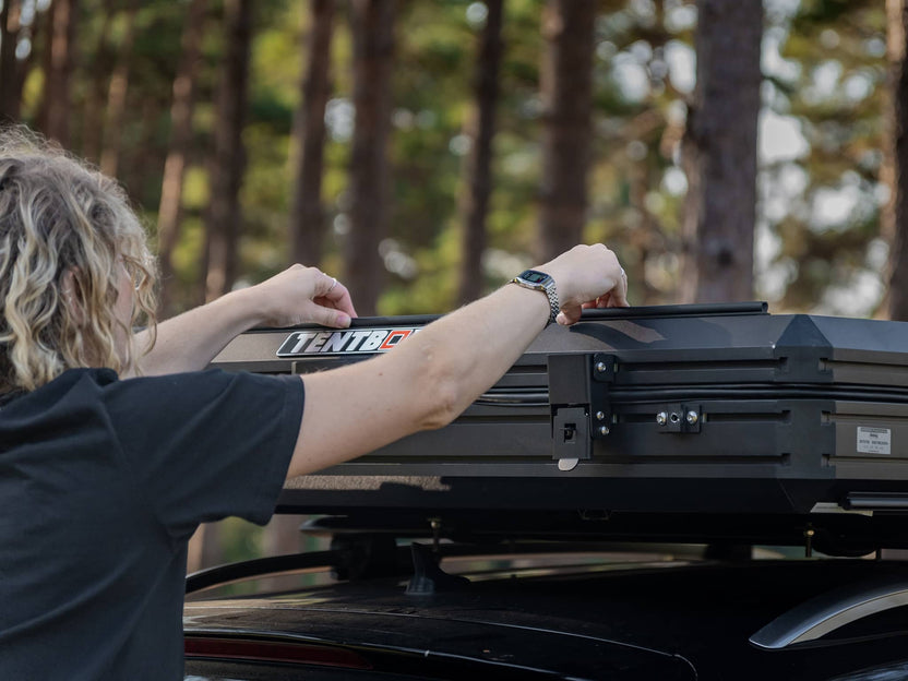 Woman installing the TentBox Cargo 1.0 Tunnel Awning