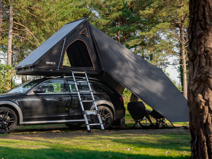 Clear side view of the TentBox Cargo 1.0 Tunnel Awning with people sat beneath