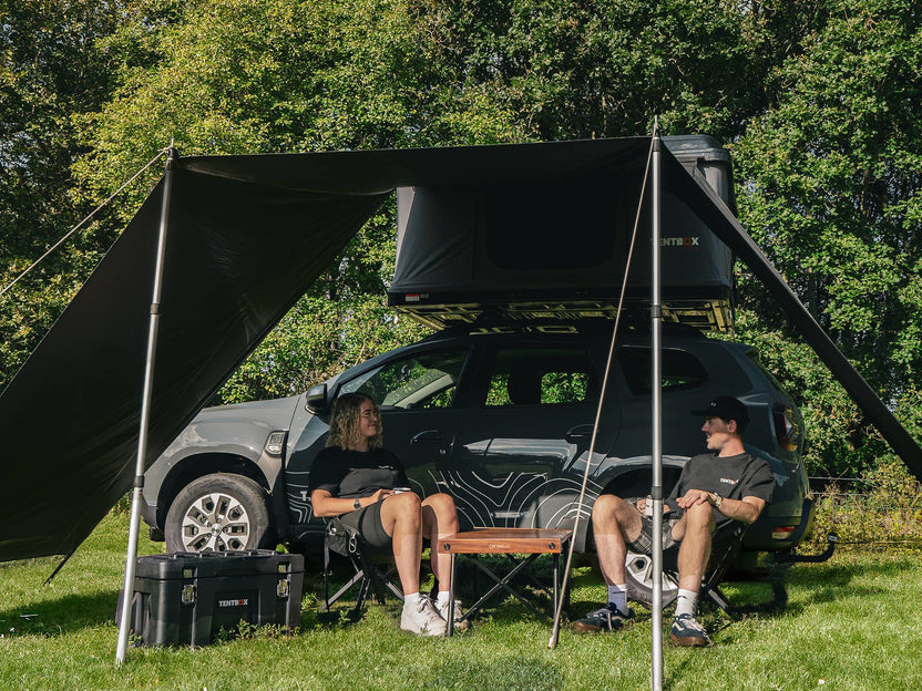 People enjoying the shelter from the sun beneath the TentBox Classic 1.0 Tunnel Awning