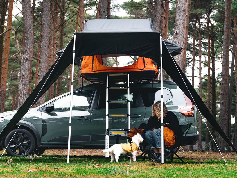 Woman and dog enjoying spending time under the TentBox Lite 1.0 Tunnel Awning
