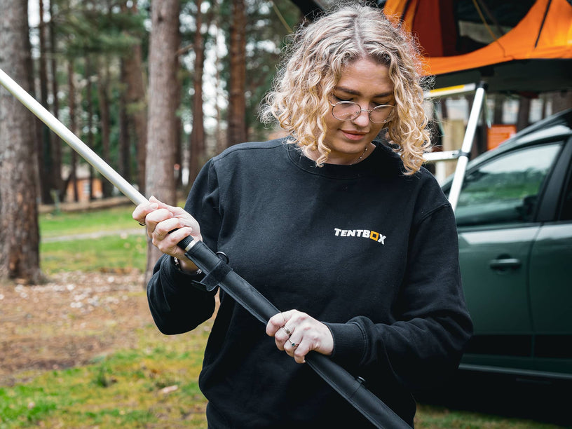 Woman installing the TentBox Lite 1.0 Tunnel Awning