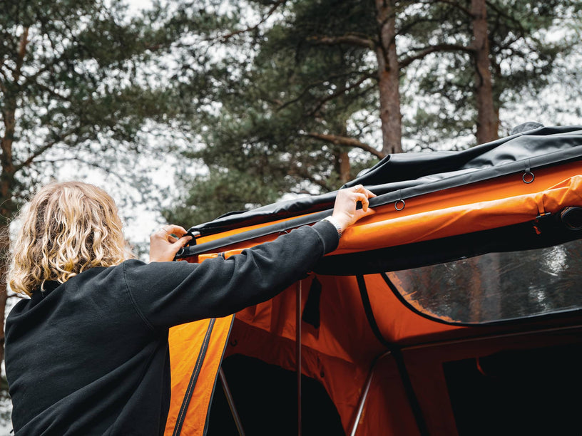 Woman installing the TentBox Lite 1.0 Tunnel Awning