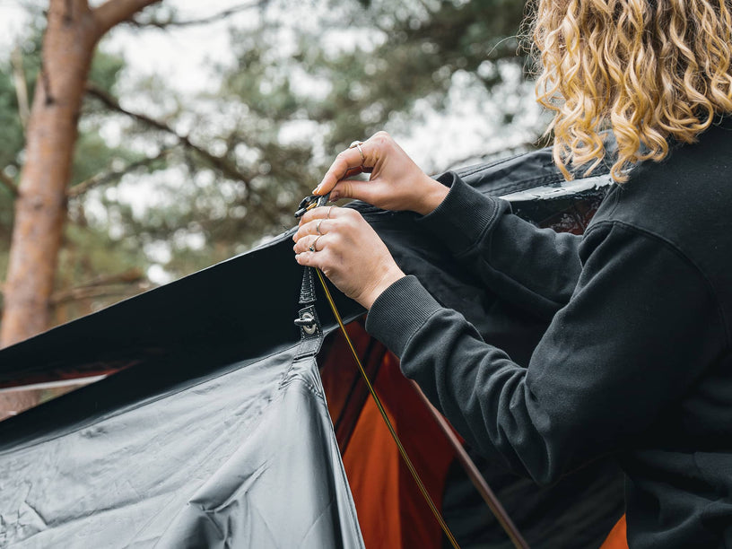 Woman installing the TentBox Lite 1.0 Tunnel Awning