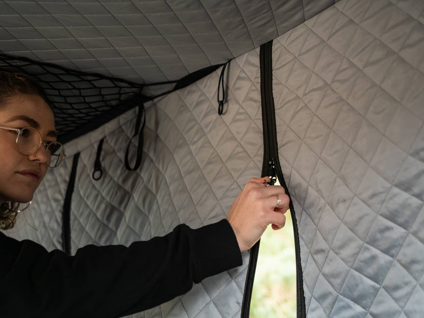 TentBox Classic Insulation Pod - woman unzipping door on insulation pod