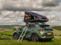 The TentBox GO roof tent on a Kia Sportage being used by a man with a dog. 