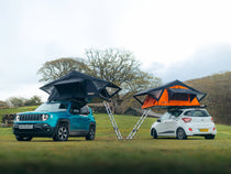 Two TentBox Lite 1.0 roof tents installed on different cars, parked at a camp site