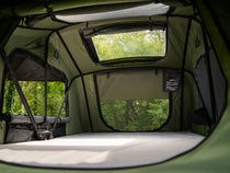 Looking inside the TentBox Lite 2.0 in the Forest Green colour, set amongst the trees.