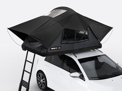 The new Flint coloured TentBox Lite roof tent open on the roof of a white car
