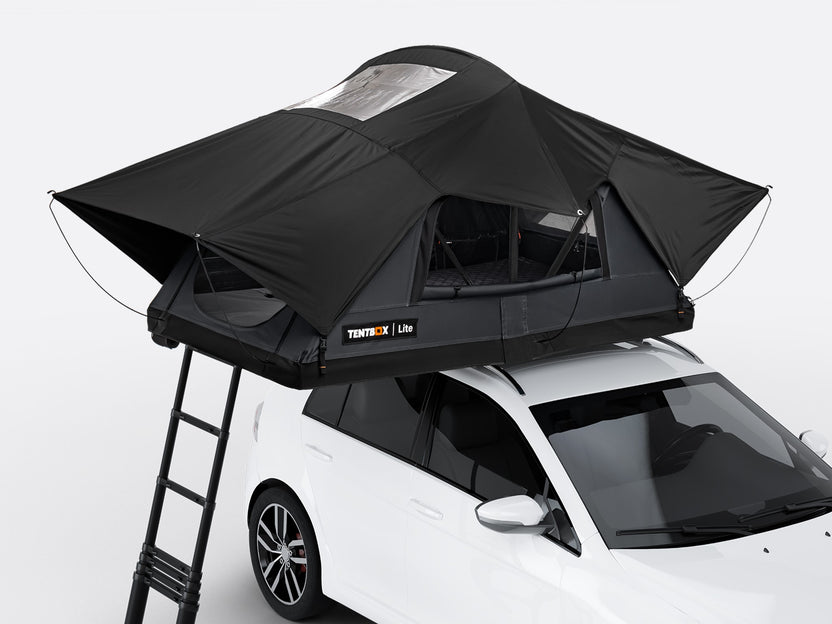The new Flint coloured TentBox Lite roof tent open on the roof of a white car