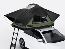 The new Forest coloured TentBox Lite roof tent open on the roof of a white car