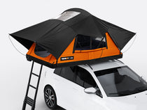 The new Sunset coloured TentBox Lite roof tent open on the roof of a white car