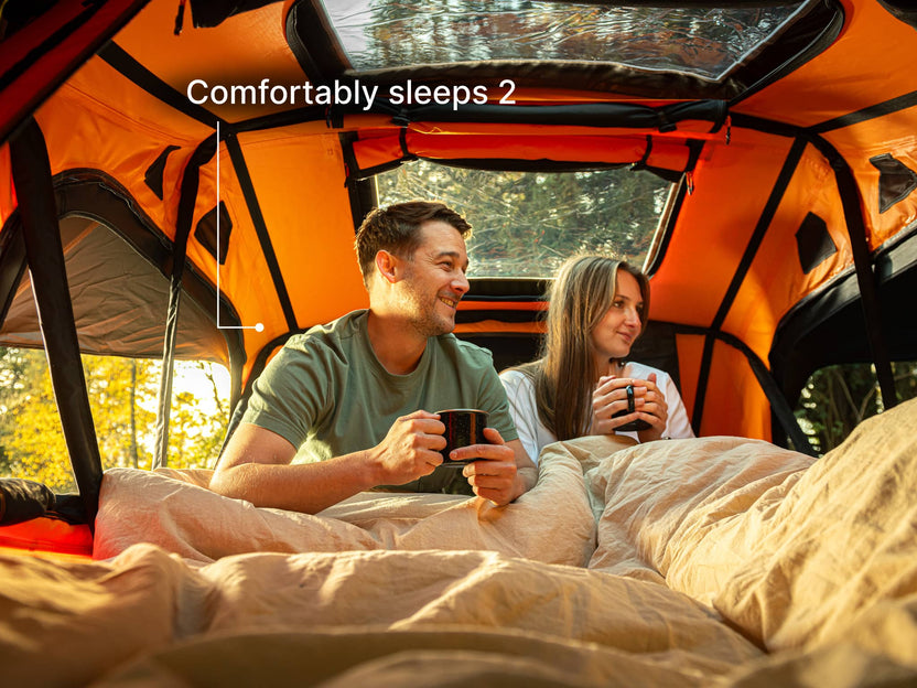 Two people in the new TentBox Lite roof tent showing it comfortably sleeps two people