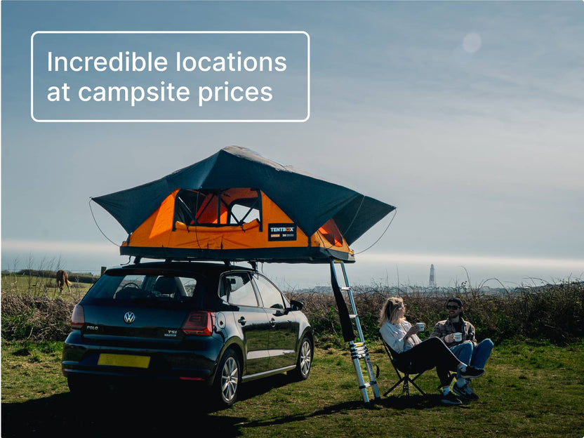 TentBox Lite 2.0 set up on a VW Golf at a coastal campsite with ocean views in the background