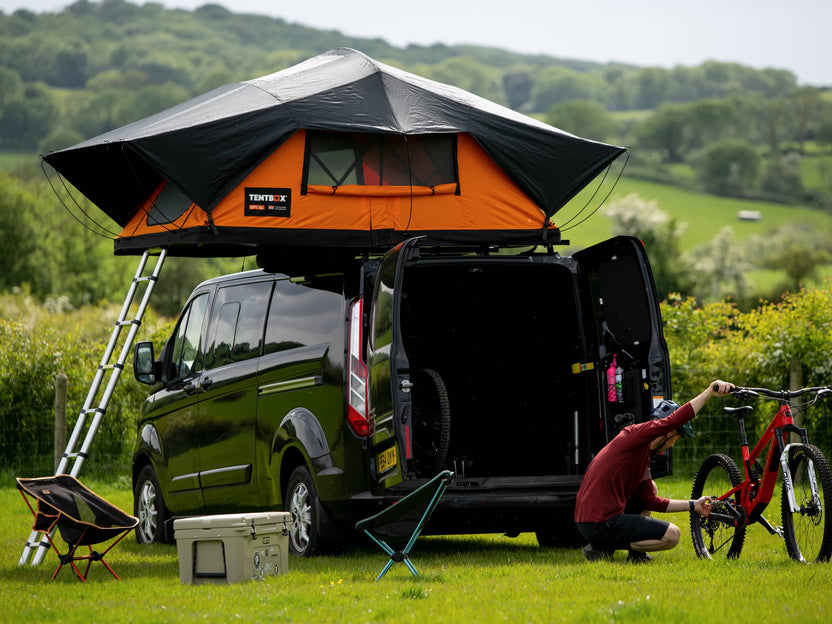 Camping in the Sunset Orange TentBox Lite XL by the trails.