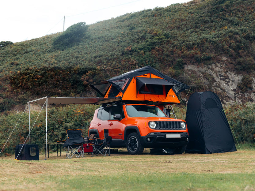 TentBox Lite 1.0 in orange, mounted to an orange Jeep, set-up at a campsite