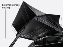 Black external storage netting attached to the underside of the TentBox Lite XL roof tent text indicating 'External storage netting'.