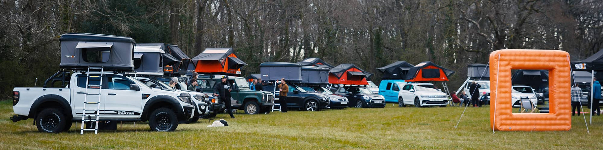 A camping field with many roof tents installed on different cars, owned by TentBox Ambassadors
