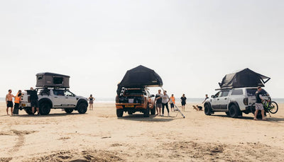 Three TentBox roof tents pitched on a beach scene
