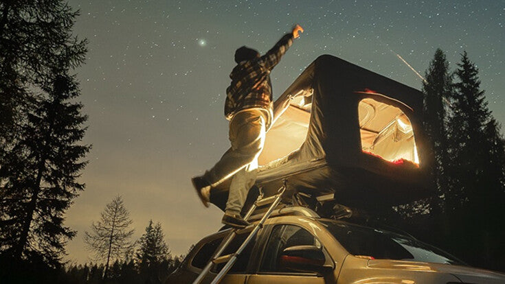 TentBox glowing on a car under a starry sky