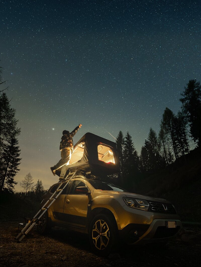TentBox glowing on a car under a starry sky