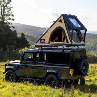 A TentBox Cargo 2.0 installed on a Land Rover Classic Defender at the top of the Peak District hills