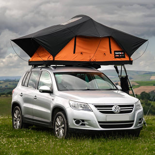 A TentBox Lite 2.0 in Sunset Orange mounted on a VW family SUV