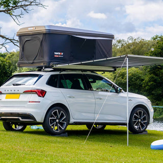 The Midnight Grey TentBox Classic 2.0 installed on a Skoda family SUV with the TentBox Side Awning installed by the lake