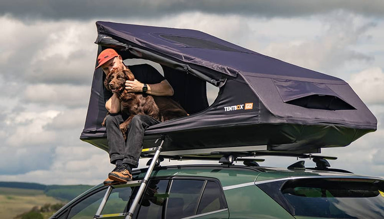 A man enjoying the simplicity of camping in his TentBox with his dog