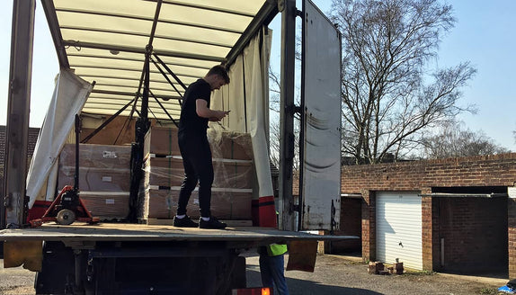 TentBox founder Neill standing with recently manufactured roof tents in boxes