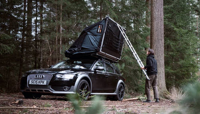 Person demonstrating how to open TentBox Lite XL roof tent